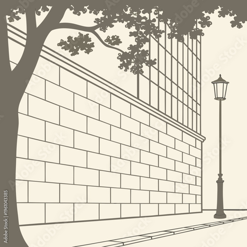 A tree beside a brick wall and a street lamp