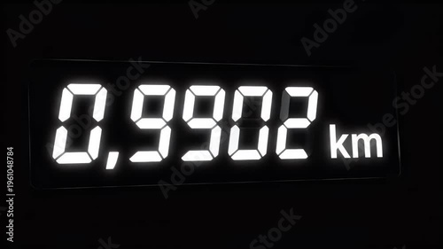Glowing digital display shows 0.9902 km