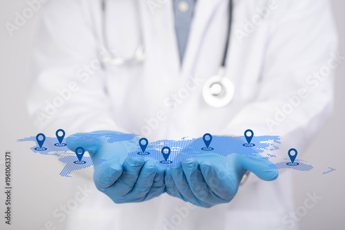 Fotografía Doctor holding digital world map with location pins representing global healthcare network, telemedicine services, international medical access and connected hospital technology worldwide