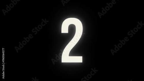 Glowing number two against a dark, black background with soft illumination