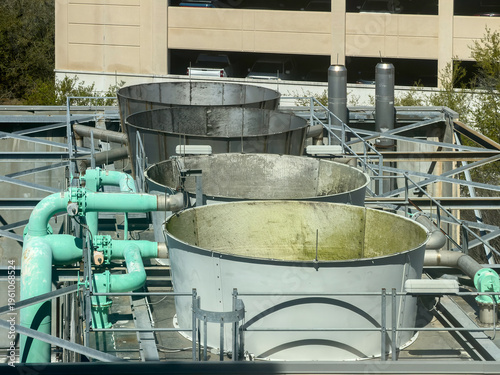 Rooftop vents and pipes for the heating, venting, and air conditioning (HVAC) system of a large modern hospital. High-angle view. For motifs of air circulation, control, and hospital microclimates.