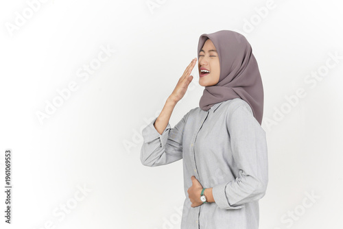 Side View of Hijab Woman Yawning and Holding Her Belly