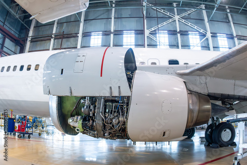 Close-up of an open high bypass turbofan airplane engine of a passenger aircraft in aviation hangar