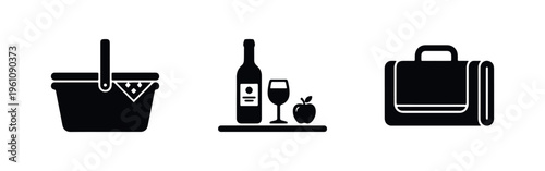 Set of black picnic icons featuring a basket, wine bottle with glass and apple, and a folded blanket, isolated on a white background.