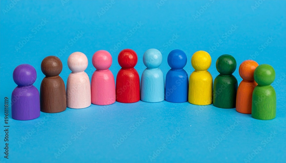 Obraz premium Vibrant Rainbow Wooden Peg Dolls in a Diverse Row Over a Bright Blue Background for Inclusion and Teamwork Concepts