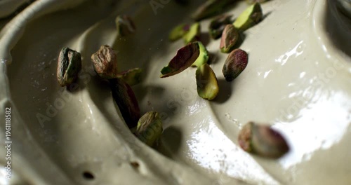 Slow Motion Macro Of Pistachio Cream Covering Dessert Close Up Concept Of Gourmet Food And Italian Cuisine
