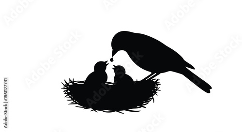 A parent bird feeding chicks in a nest black silhouette