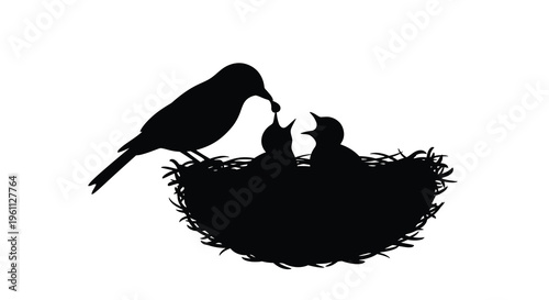 A mother bird feeding her chicks in a nest black silhouette