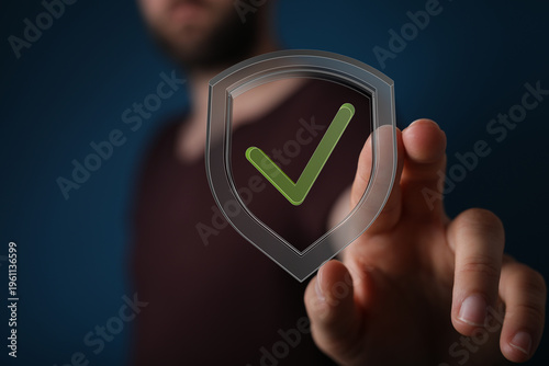 Hand touching a shield with...