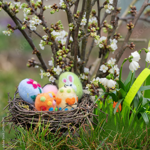 happy easter with fresh blooming branches and colorful easter eggs
