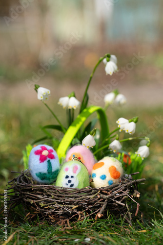 cute self created easter eggs in a nest in the garden