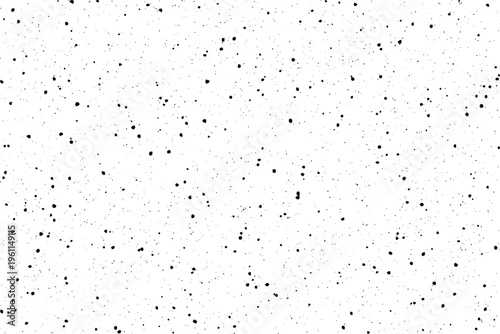 A random pattern of numerous scattered black flecks and tiny specks distributed across a pristine white surface