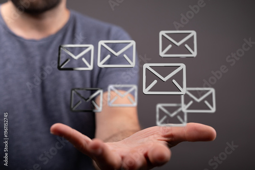 Man holding floating email ...