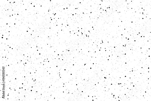 Countless small black dots irregularly populate a bright white field, forming an organic speckled pattern