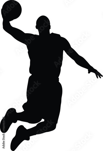 Silhouette of a basketball player in mid air dunking a ball