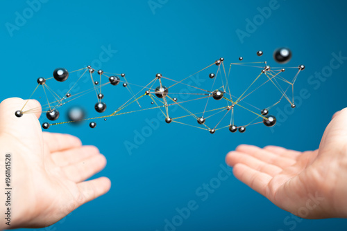An abstract network floating between two hands, symbolizing connection, innovation, and global communication. Modern te