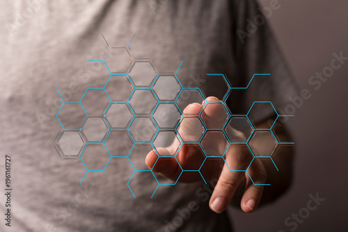 Person interacting with a futuristic digital interface, touching a hexagon grid representing network, concepts like AI,