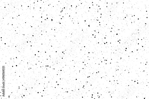 Unevenly distributed black particles against a clean white backdrop generate a raw textured appearance