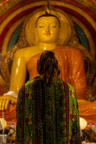 Woman Praying in Front of Buddha Statue in Colombo Sri Lanka Temple