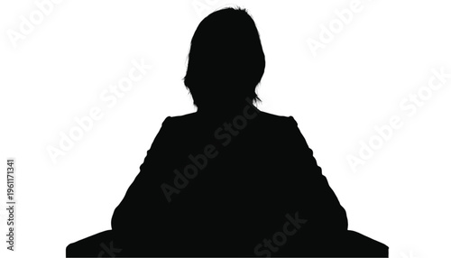 Silhouette of a professional figure seated behind a wide desk or counter presenting forward.