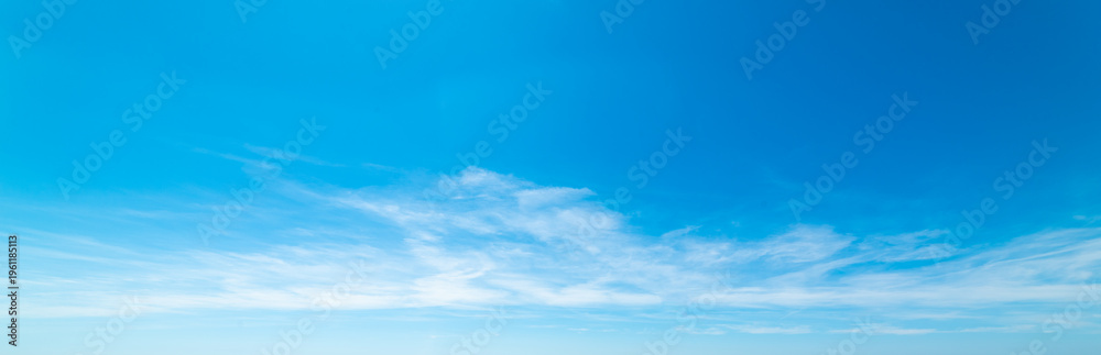 Fototapeta premium Blue sky with few small white soft clouds