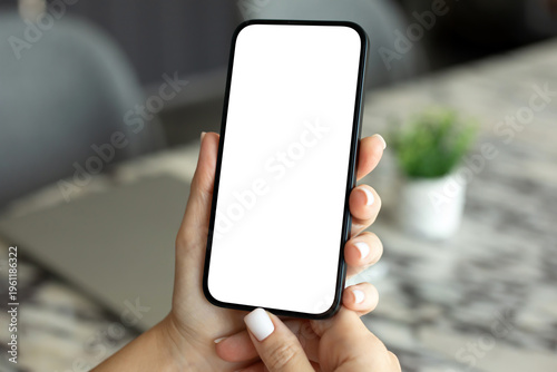 woman hand holds phone with isolated screen background table office