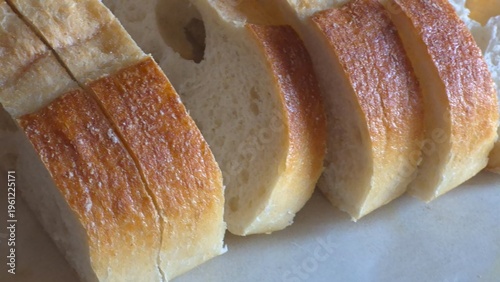 Freshly Sliced Crusty Baguette, White Bread on a Marble Surface, Healthy Food Concept