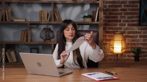 Business woman shows report and discusses with colleague online during work meeting.
