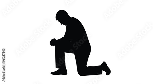 Man kneeling in prayer head bowed with hands clasped silhouette