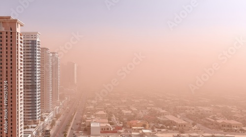 Thick brown smog covers urban buildings and skyline in dense haze leading to low visibility in city