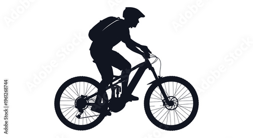 Cyclist riding a mountain bike depicted in a dark silhouette