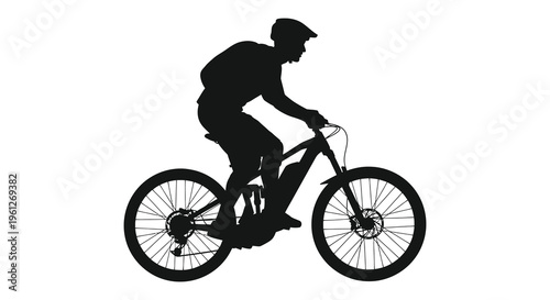 Mountain biker riding dynamic pose captured in stark silhouette