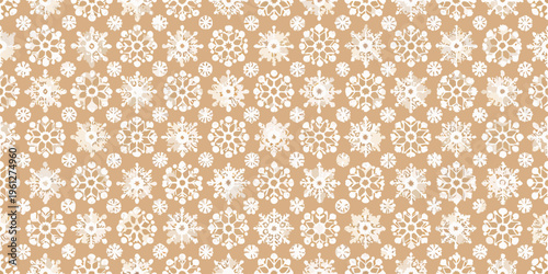 Seamless pattern of delicate white snowflakes on a warm beige background