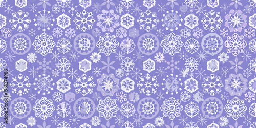 Seamless pattern of delicate white snowflakes on a lavender background