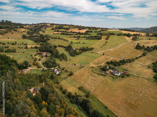 Panoramic aerial view of Sudetes mountains countryside, Lower Silesia, Poland. Rural landscape with fields, forests and farm houses.