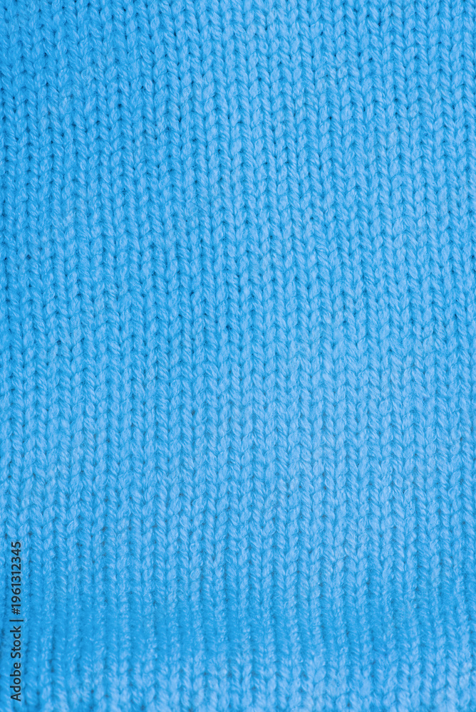 Fototapeta premium Blue knitted texture macro photo. Knitted clothes as background.