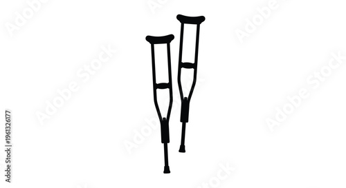 Pair of black crutches stand against a white background silhouette