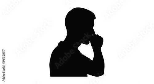 A man in thoughtful contemplation hand to chin in silhouette