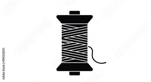 A black spool of thread with string a striking silhouette