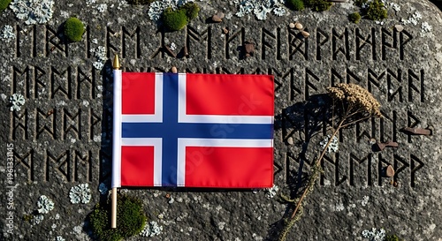 Norwegian flag on ancient rune stone with moss and dried plant life on textured background.