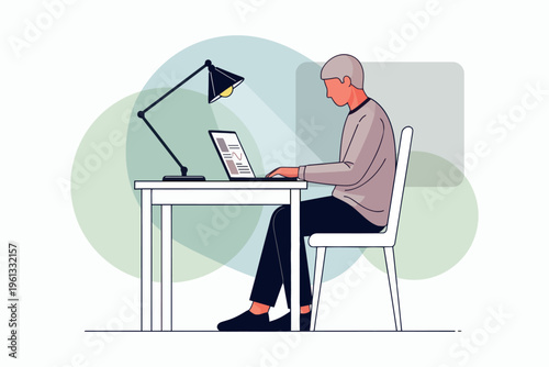 Man working on a laptop at a desk with a focused expression