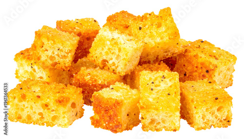 Golden, seasoned bread cubes piled together against a transparent background