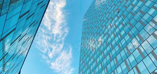 Office building. Skyscrapers in business center. Modern architecture, glass curved facade of residential or commercial real estate, blue sky background