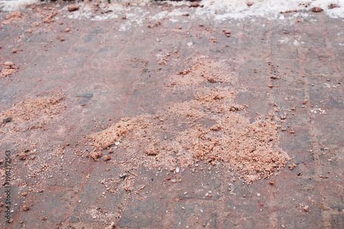 A hill of anti-ice mixture lies on the road