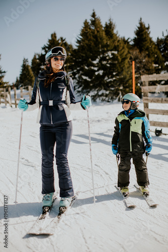 Woman and child ski togethe...