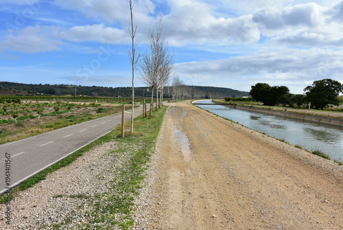 Canal of river Ebre and cycleway near town Tortosa in Spain