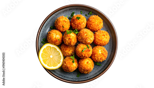 Golden-brown, breaded fried balls arranged on a plate with lemon and parsley