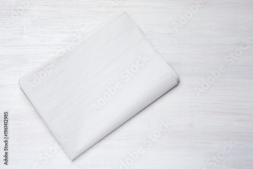 Newspaper on white wooden table, top view. Mockup for design