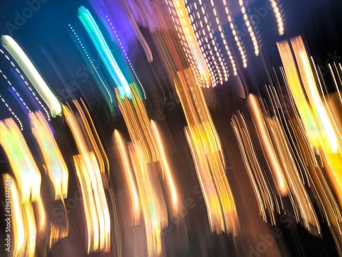 Nighttime urban glow with movement. Vivid city nightlife captured through energetic streaks of neon and busy traffic flows