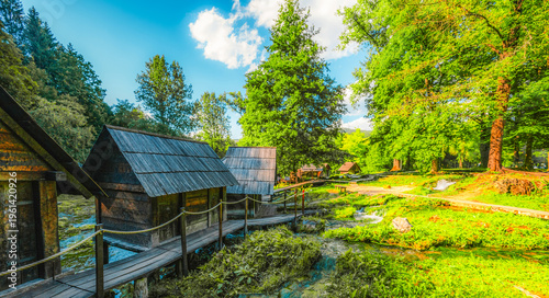 Foto Historic wooden watermills (Mlincici) on the travertine barriers of Plivsko Lake near Jajce, Bosnia and Herzegovina